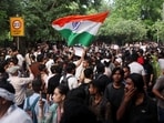 A supporter of India's Cockroach Janata Party (CJP) holds an Indian national flag at the ongoing protest site.(REUTERS)