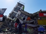 People look for survivors amid the rubble of a collapsed building after an earthquake in Pereira, Colombia.