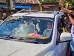 Security officials and police personnel form a protective wall around the vehicle carrying former West Bengal Chief Minister and Trinamool Congress (TMC) chief Mamata Banerjee as agitated demonstrators attack her convoy (PTI)
