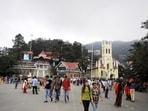 Residents and tourists enjoying pleasant, cloudy weather on The Ridge in Shimla on Wednesday. (Deepak Sansta / HT)