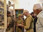 Security officials conduct a search operation in connection with a UAPA case registered against banned organisation Jamaat-e-Islami (JeI), in Sopore, Jammu and Kashmir, on Sunday. (PTI)