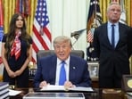 President Donald Trump speaks as Health and Human Services Secretary Robert F. Kennedy Jr., right, and Jayme Franklin listen during a meeting to sign an executive order about vaccines in the Oval Office of the White House in Washington. 