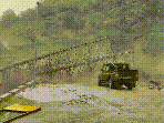A video of the incident shows a powerful surge of muddy water rushing through the valley and hitting the metal bridge.(HT sourced)