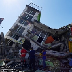 People look for survivors amid the rubble of a collapsed building after an earthquake in Pereira, Colombia.