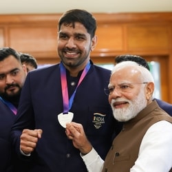 Prime Minister Narendra Modi with boxer Narender Berwal during a felicitation ceremony for India's Glasgow 2026 Commonwealth Games contingent at the Prime Minister's residence