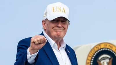 US President Donald Trump gestures as he boards Air Force One on August 9, 2026 at Morristown Airport in Morristown, New Jersey. US President Donald Trump gestures as he boards Air Force One on August 9, 2026 at Morristown Airport in Morristown, New Jersey.