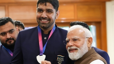 Prime Minister Narendra Modi with boxer Narender Berwal during a felicitation ceremony for India's Glasgow 2026 Commonwealth Games contingent at the Prime Minister's residence in New Delhi.