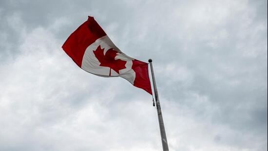 A Canadian flutters at the Canada-US border in Saint-Bernard-de-Lacolle, Quebec, Canada. (Bloomberg)