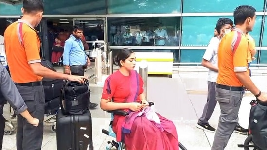 Medical pesonnel present with an injured crew member in a wheelchair as Air India flight (AI2379) from Phuket to Delhi experienced brief in-flight turbulence.