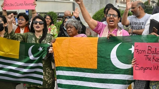 Women's rights activists shout slogans during a protest in Karachi following unrest during the first phase of polling for the local legislature in Pakistan-occupied Kashmir.