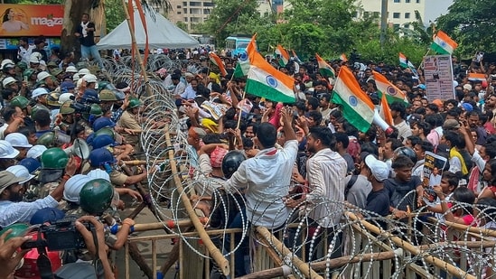 Security personnel try to stop student protesters and job aspirants marching towards the Jharkhand legislative assembly in Ranchi on Monday, August 10, 2026.