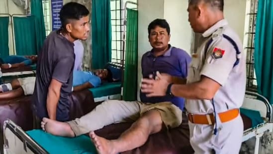 A police official interacts with an injured victim after some miscreants opened fire from Arunachal Pradesh along the inter-state border, leaving at least eight Assam residents injured in this incident, in Dhemaji district, Assam, Monday, Aug. 10, 2026. (PTI)