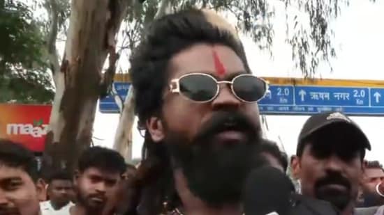'Pushpa' refers to Pushpa Raj, the fictional character played by Allu Arjun in the Pushpa film. Known for his defiant attitude and the catchphrase "Jhukega nahi", the character has become a popular symbol of resilience