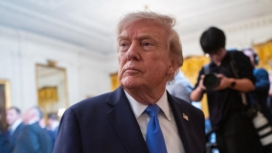 Trump signs an executive order in the Oval Office calling for the MMR vaccine to be split into three separate shots. (Bloomberg)