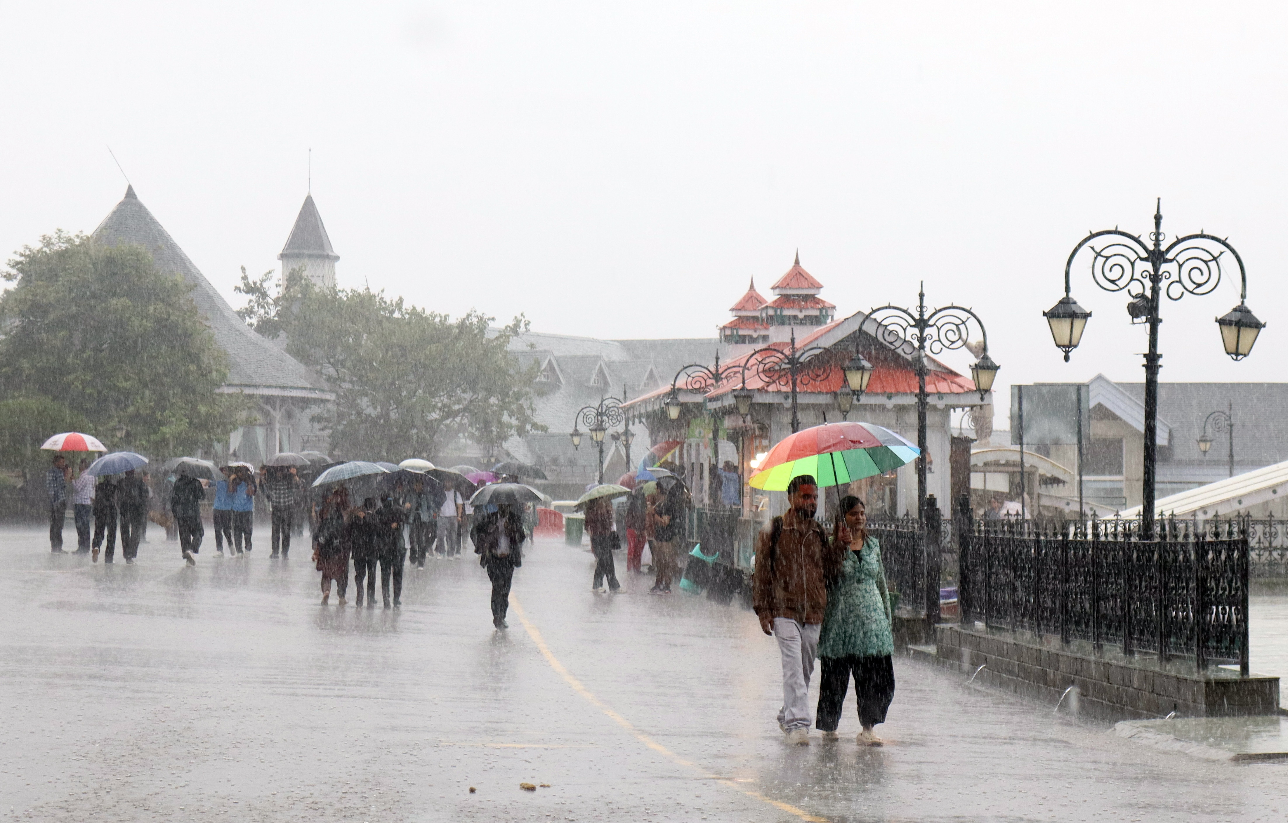 People walk under umbrellas amid heavy monsoon showers, in Shimla last week. (Satnam Gill/ANI Photo) People walk under umbrellas amid heavy monsoon showers, in Shimla last week. (Satnam Gill/ANI Photo)