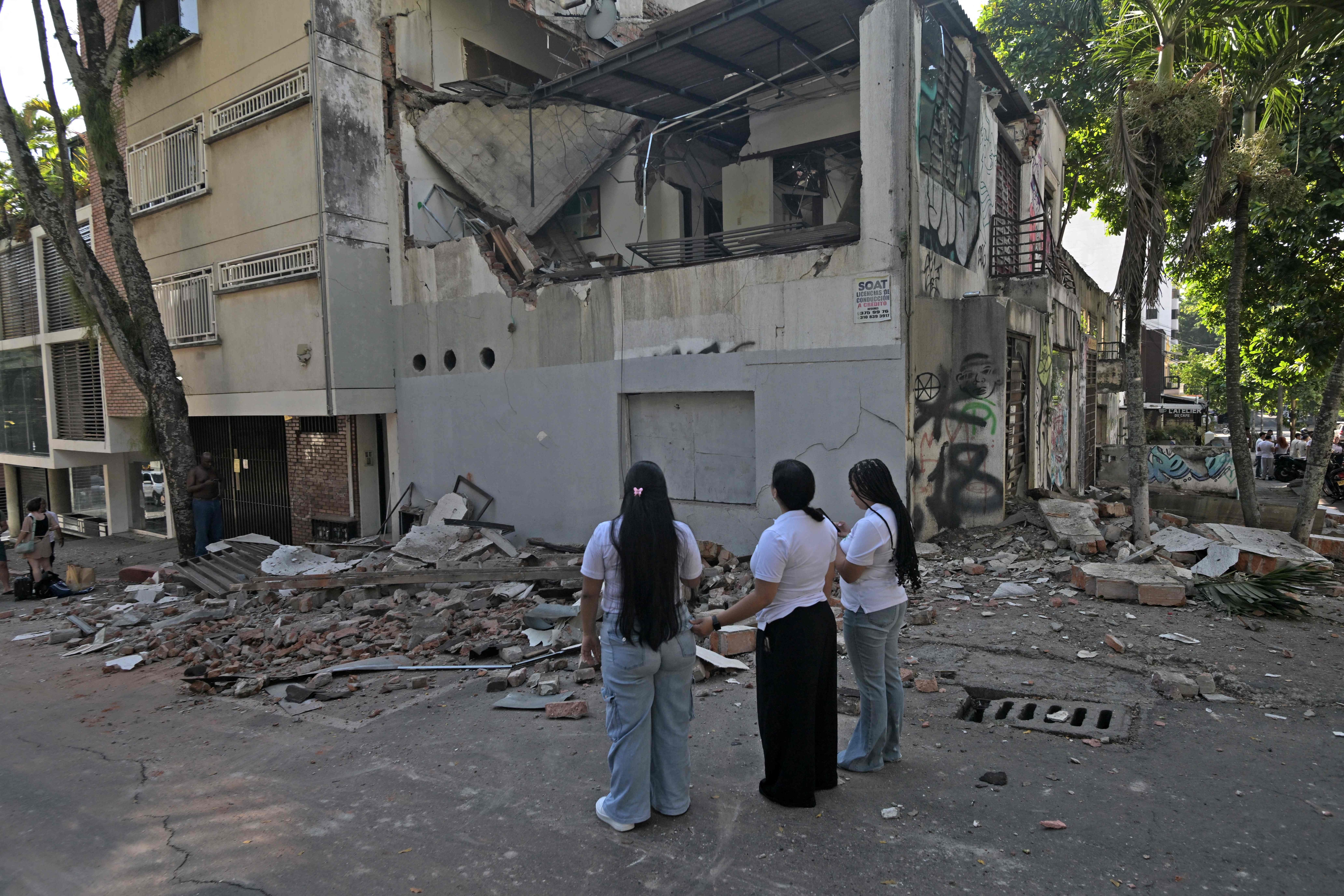 Women look at a damaged building after an earthquake, in Cali, Colombia on August 10, 2026. The earthquake rocked Colombia and other Latin American countries on August 10, 2026, shaking buildings in Bogota and in Quito, Ecuador. It was felt as far away as Panama to the north. (AFP Photo)