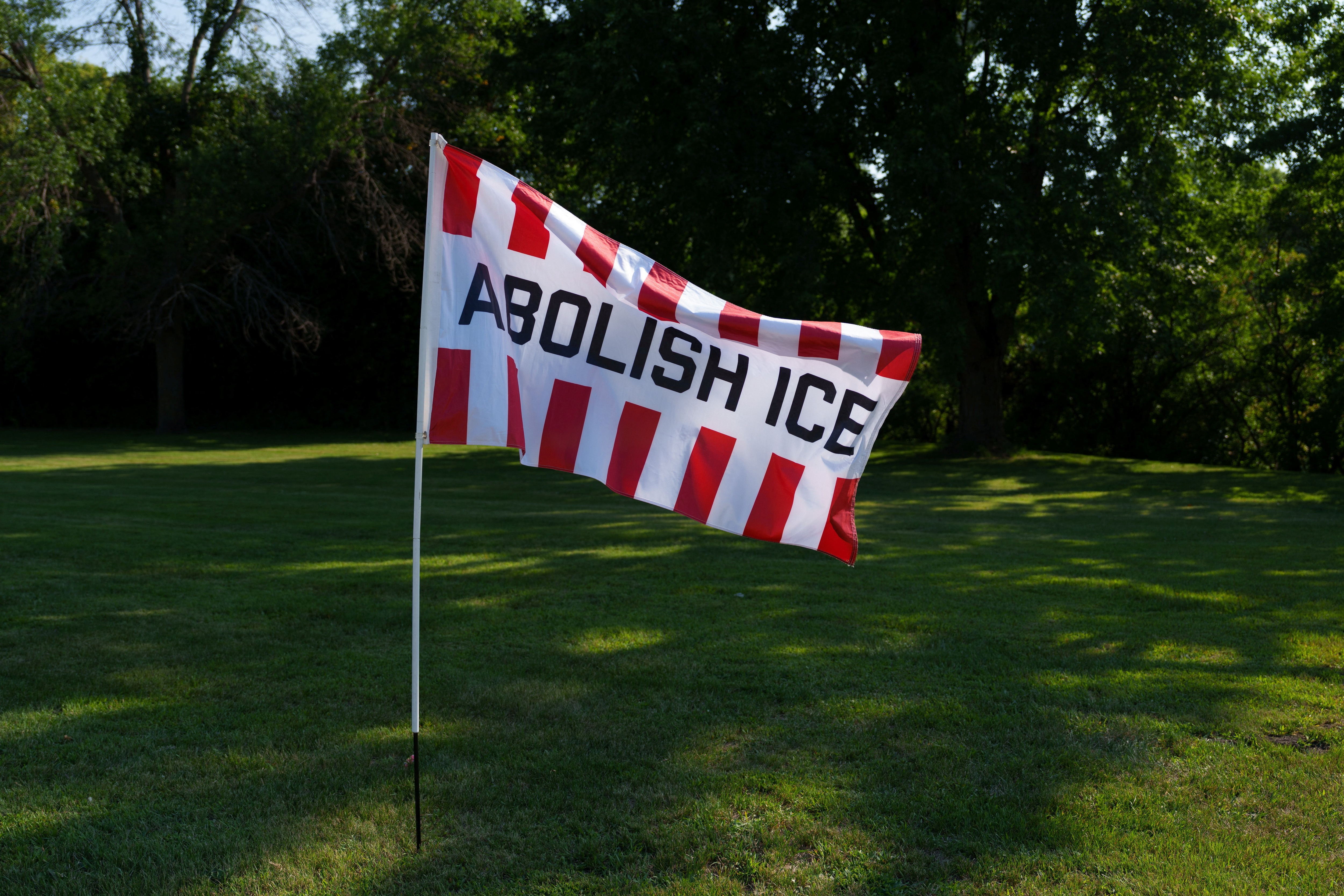 An “ABOLISH ICE” flag waves during a protest against a new Immigration and Customs Enforcement (ICE) detention center set to open in the small town of Appleton, Minnesota. (Reuters)