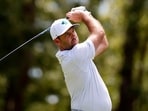 Television cameras captured a fish surfacing and grabbing Charl Schwartzel’s golf ball from beneath the water.