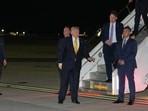 As Defense Secretary Pete Hegseth watches at left, President Donald Trump gestures as he switches planes at US Air Force Base, RAF Mildenhall in Suffolk Eastern England, on his way back to Washington from the NATO summit in Ankara, Turkey, Wednesday, July 8, 2026. 