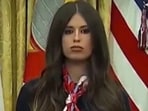Jayme Franklin's presence behind Trump at a vaccine announcement led to her being humorously labeled as 'AI Bobblehead Barbie' due to her constant nodding.