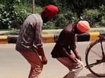 The video featured two men wearing turbans and standing motionless in a hunched back position.(X/@harbhajan_singh)
