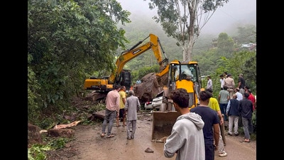 Earthmovers clear a massive boulder that crushed a moving car on National Highway 205 (NH-205) near Bharari Ghat in the Darlaghat area of Solan district, on Tuesday. (PTI)