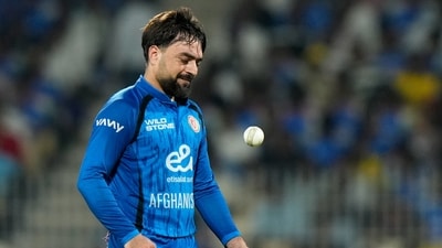 Rashid Khan tosses the ball in the air as he prepares to bowl during a match between Afghanistan and India. (AP Photo/Mahesh Kumar A.)