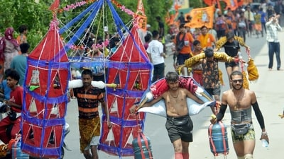 Shiva devotees carrying holy Ganga water from Haridwar walk along the Delhi-Meerut Road during the Kanwar Yatra. (HT Photo/representational)