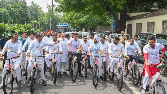 AAP MLAs Saurabh Bharadwaj and Sanjeev Jha, along with others, cycle to the Delhi Assembly as part of a symbolic protest against the alleged bicycle scam in the Delhi government, near Ambedkar Memorial, Civil Lines, in New Delhi on Monday. (vipin kumar)
