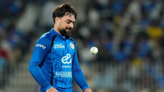 Rashid Khan tosses the ball in the air as he prepares to bowl during a match between Afghanistan and India.