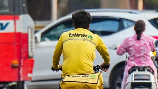 A Blinkit delivery worker pedles a bicycle, in Mumbai.