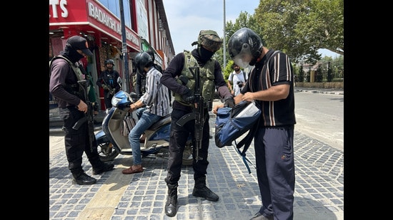 Special Operations Group checks a pedestrian's bag during a surprise search operation in Srinagar on Tuesday. (Waseem Andrabi/HT)