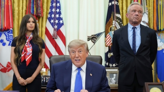 President Donald Trump speaks as Health and Human Services Secretary Robert F. Kennedy Jr., right, and Jayme Franklin listen during a meeting to sign an executive order about vaccines in the Oval Office of the White House in Washington. (AP Photo/Jacquelyn Martin)