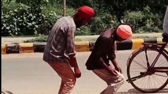The video featured two men wearing turbans and standing motionless in a hunched back position.