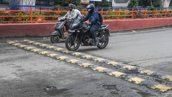 Speed breakers are intentionally painted in contrasting colours to improve visibility.