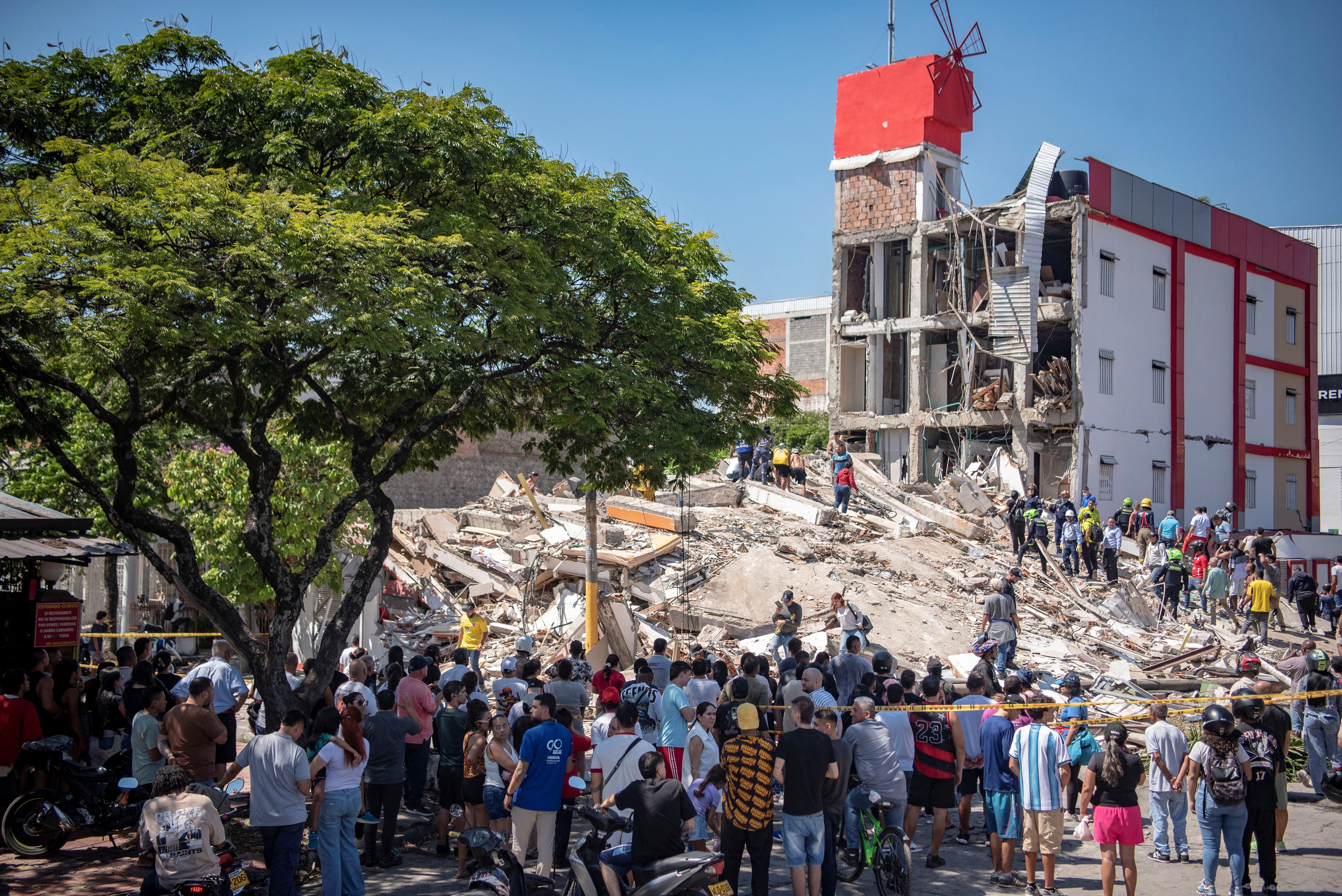 Residents and emergency personnel dig through the debris of a collapsed building after an earthquake, in Cali, Colombia, (REUTERS)