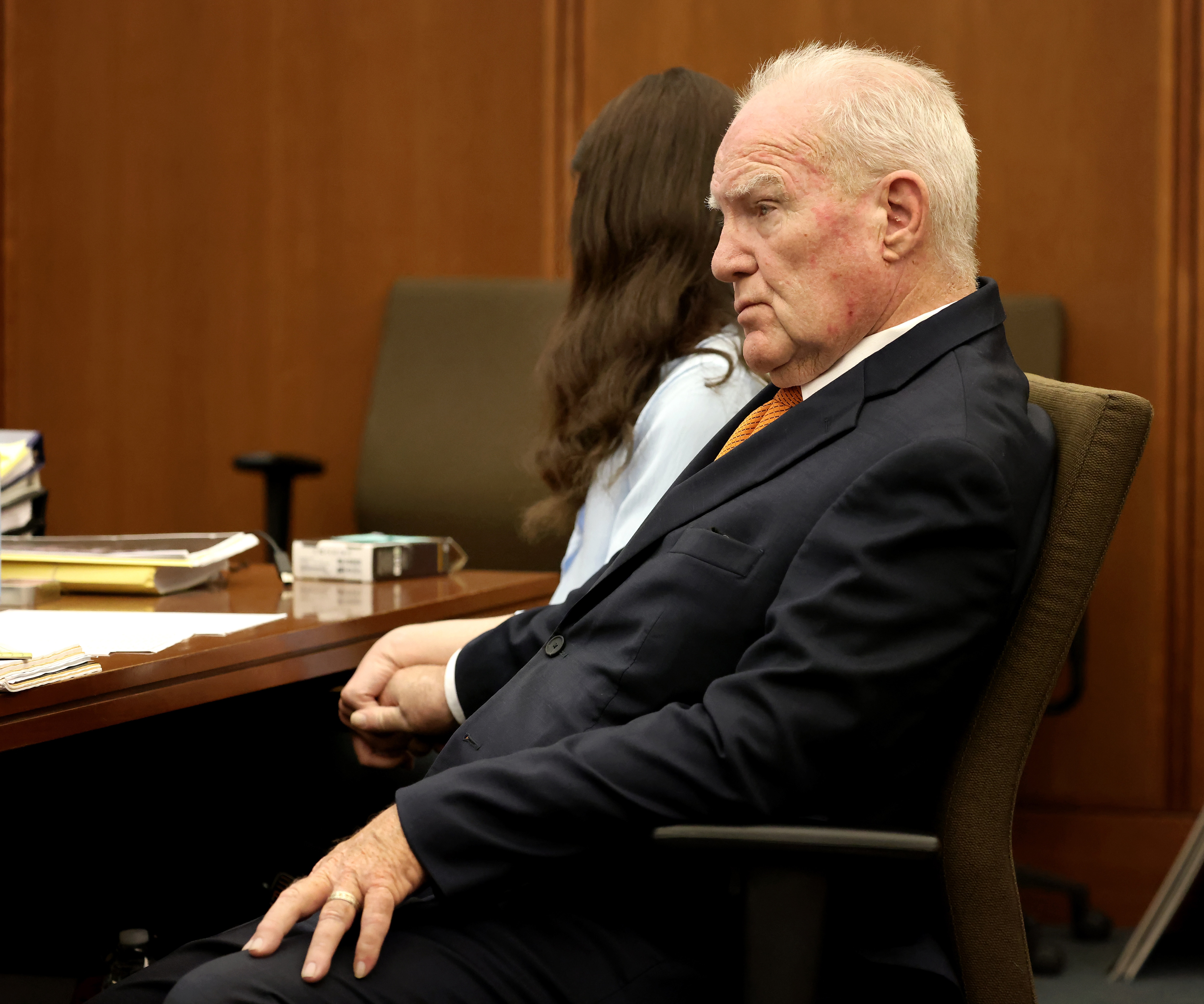 Defense attorney Kevin Reddington holds the hand of Lindsay Clancy while listening to the 911 recording from the day of the murder. (AP)