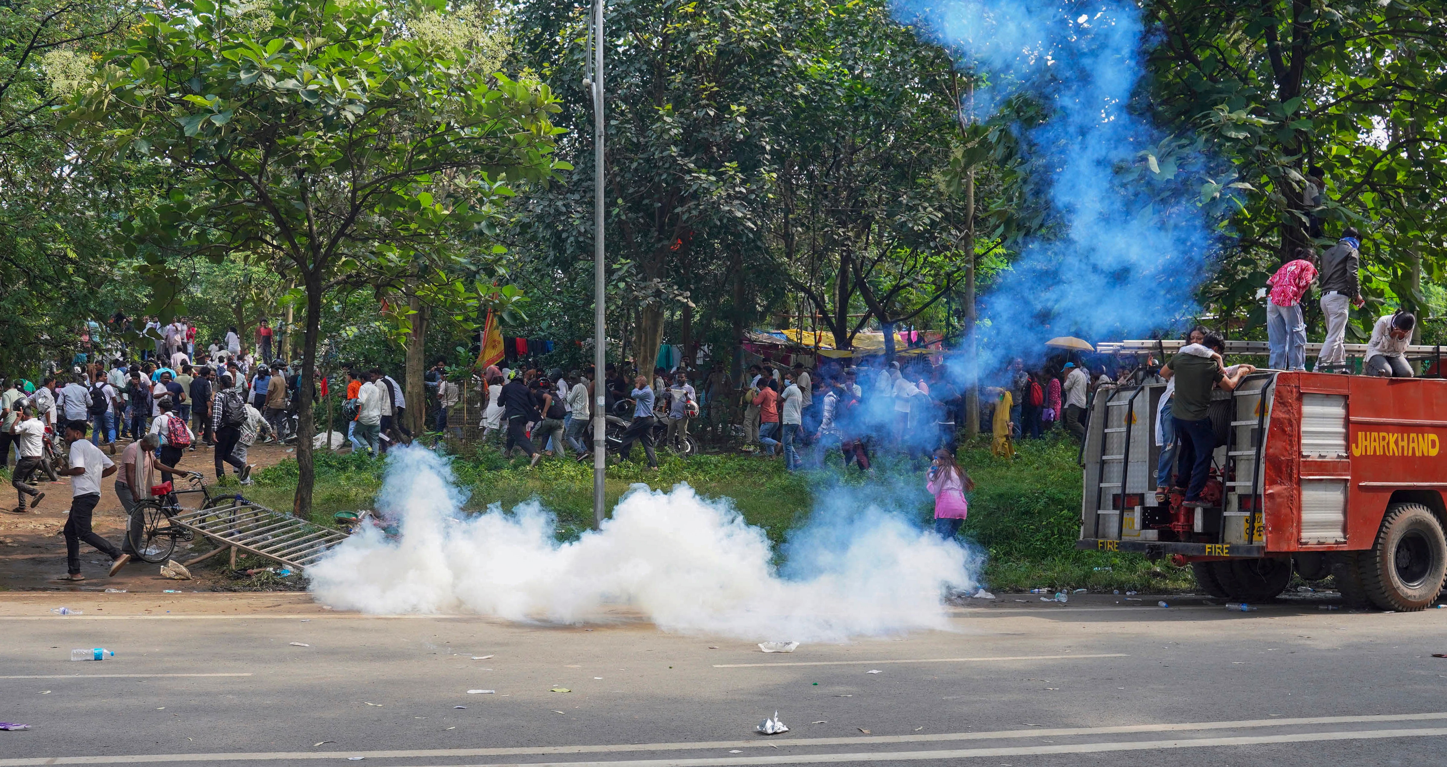 Smoke fills the area as security forces fire tear gas shells to disperse student protesters marching towards the Jharkhand Legislative Assembly in Ranchi on Monday. (PTI) Smoke fills the area as security forces fire tear gas shells to disperse student protesters marching towards the Jharkhand Legislative Assembly in Ranchi on Monday. (PTI)