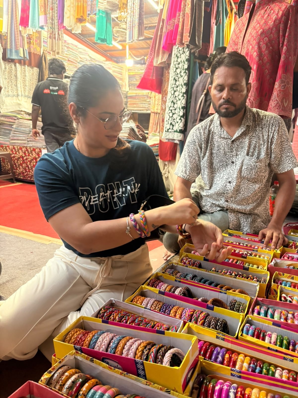 Smiley Sharma Das, a visitor, trying lac bangles at Teej Mela. (Photo: Anshita Jain/HT) Smiley Sharma Das, a visitor, trying lac bangles at Teej Mela. (Photo: Anshita Jain/HT)