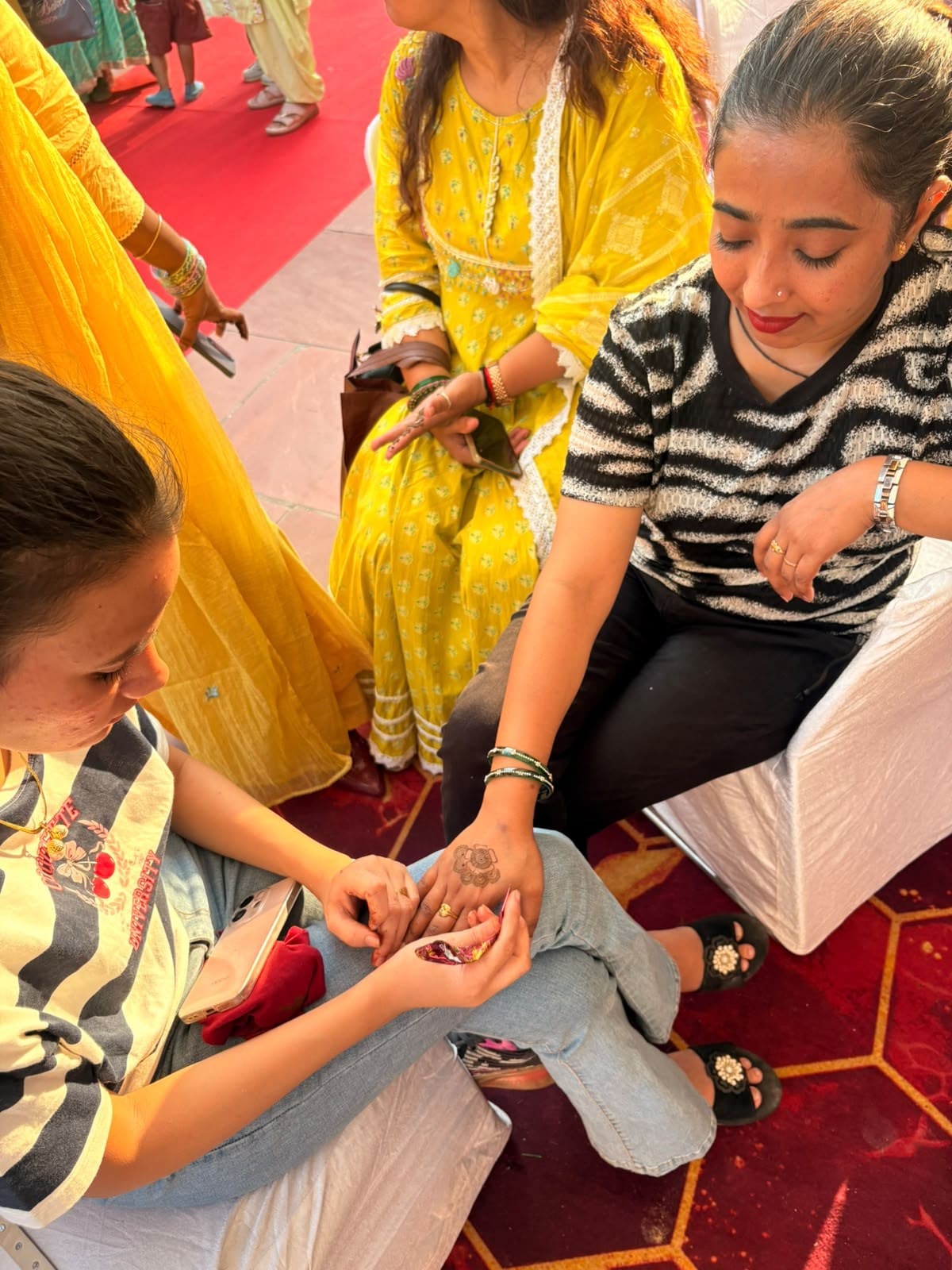 Sanaa, a visitor getting mehendi applied on their hands. (Photo: Anshita Jain/HT) Sanaa, a visitor getting mehendi applied on their hands. (Photo: Anshita Jain/HT)
