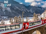 A scenic Swiss train winds through dramatic Alpine landscapes, offering travellers a memorable way to experience Switzerland at a slower pace.