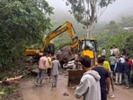 Earthmovers clear a massive boulder that crushed a moving car on National Highway 205 (NH-205) near Bharari Ghat in the Darlaghat area of Solan district, on Tuesday. (PTI)