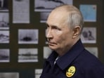 Russia's President Vladimir Putin visits the Russian Navy's guided missile cruiser Varyag as he oversees the final stage of a Pacific Fleet's naval drills on far eastern Sakhalin Island