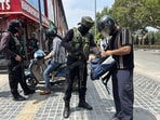 Special Operations Group checks a pedestrian's bag during a surprise search operation in Srinagar on Tuesday. (Waseem Andrabi/HT)
