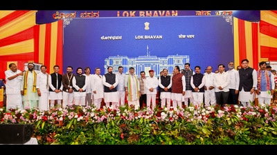 Karnataka chief minister DK Shivakumar and Governor Thawar Chand Gehlot pose with newly inducted ministers and other leaders after the swearing-in ceremony following the expansion of the state Cabinet at Lok Bhavan in Bengaluru. (X/DKShivakumar)