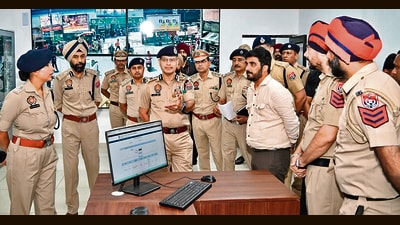 Punjab DGP Gaurav Yadav interacting with police personnel at the integrated command and control centre on Wednesday. (HT PHOTO)