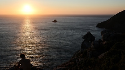 A tourist looks at the sunset the day before the solar eclipse, on the Costa da Morte ("Coast of Death"). (REUTERS)