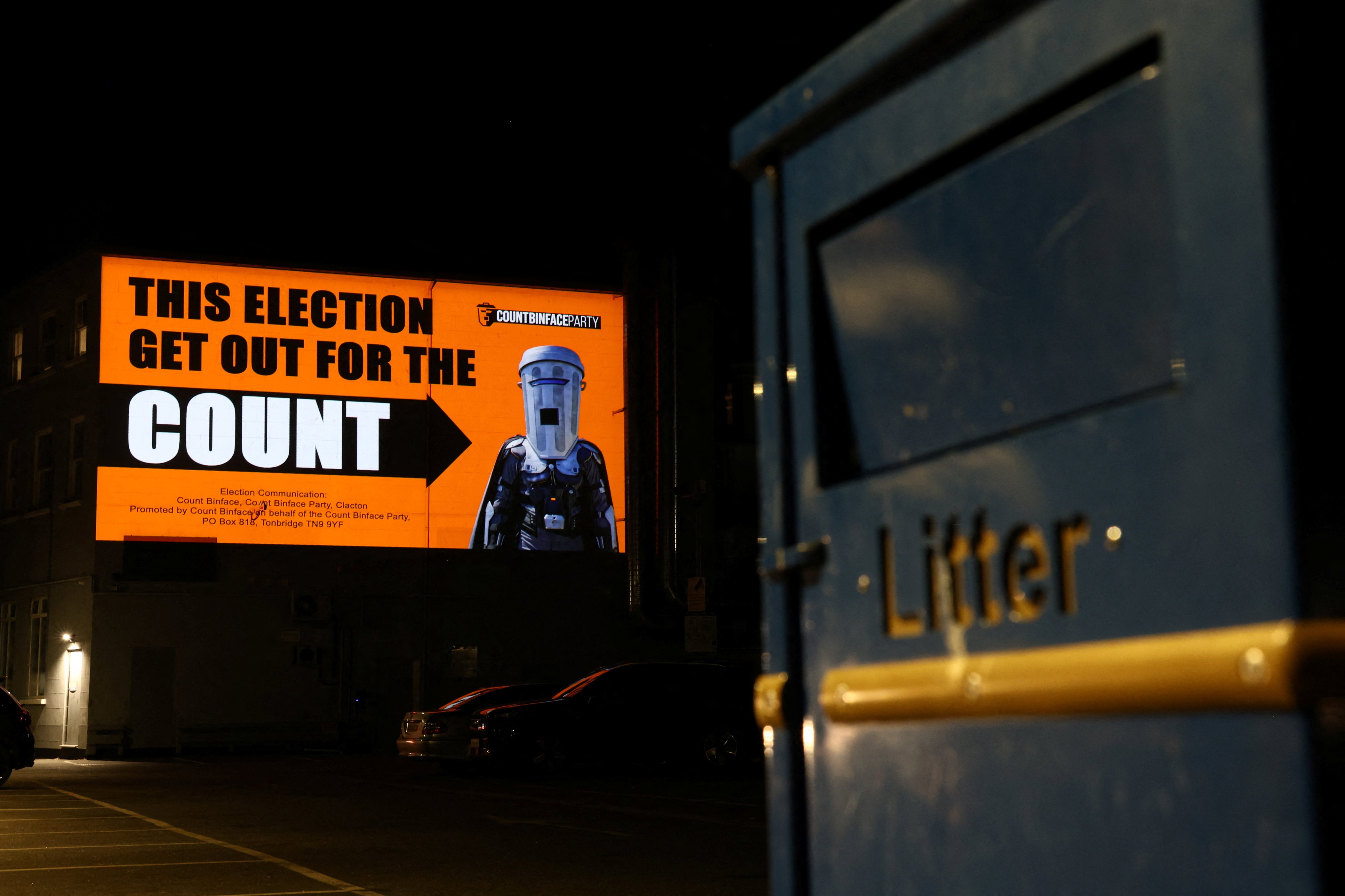 An image of Count Binface, a parliamentary candidate in the Clacton by-election and sole challenger to Reform UK party leader Nigel Farage, is projected onto a building near Clacton Pier. (REUTERS)