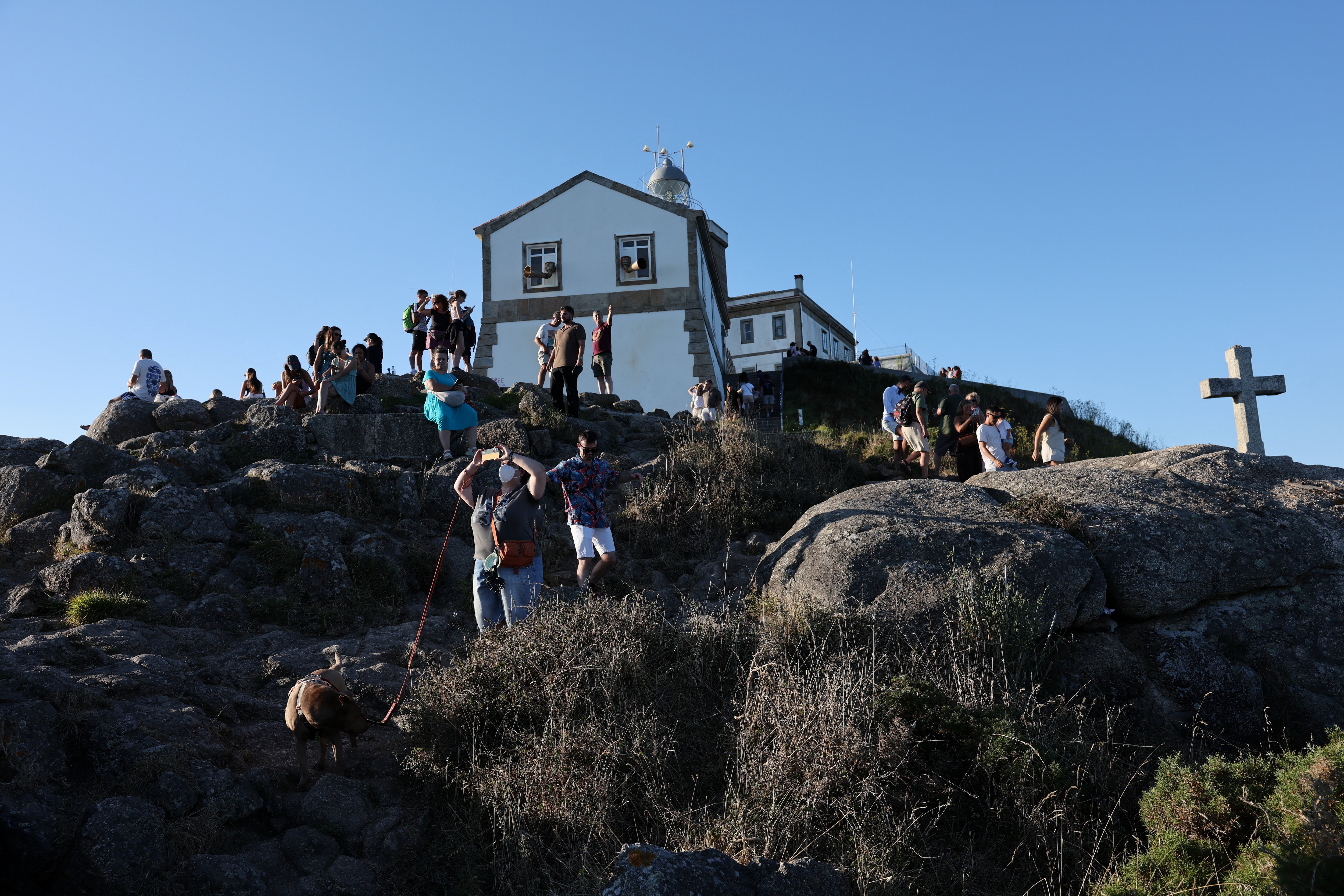 Tourists visit Cape Fisterra the day before the solar eclipse, at the Costa de la Muerte in northwestern Spain. (Reuters Photo)