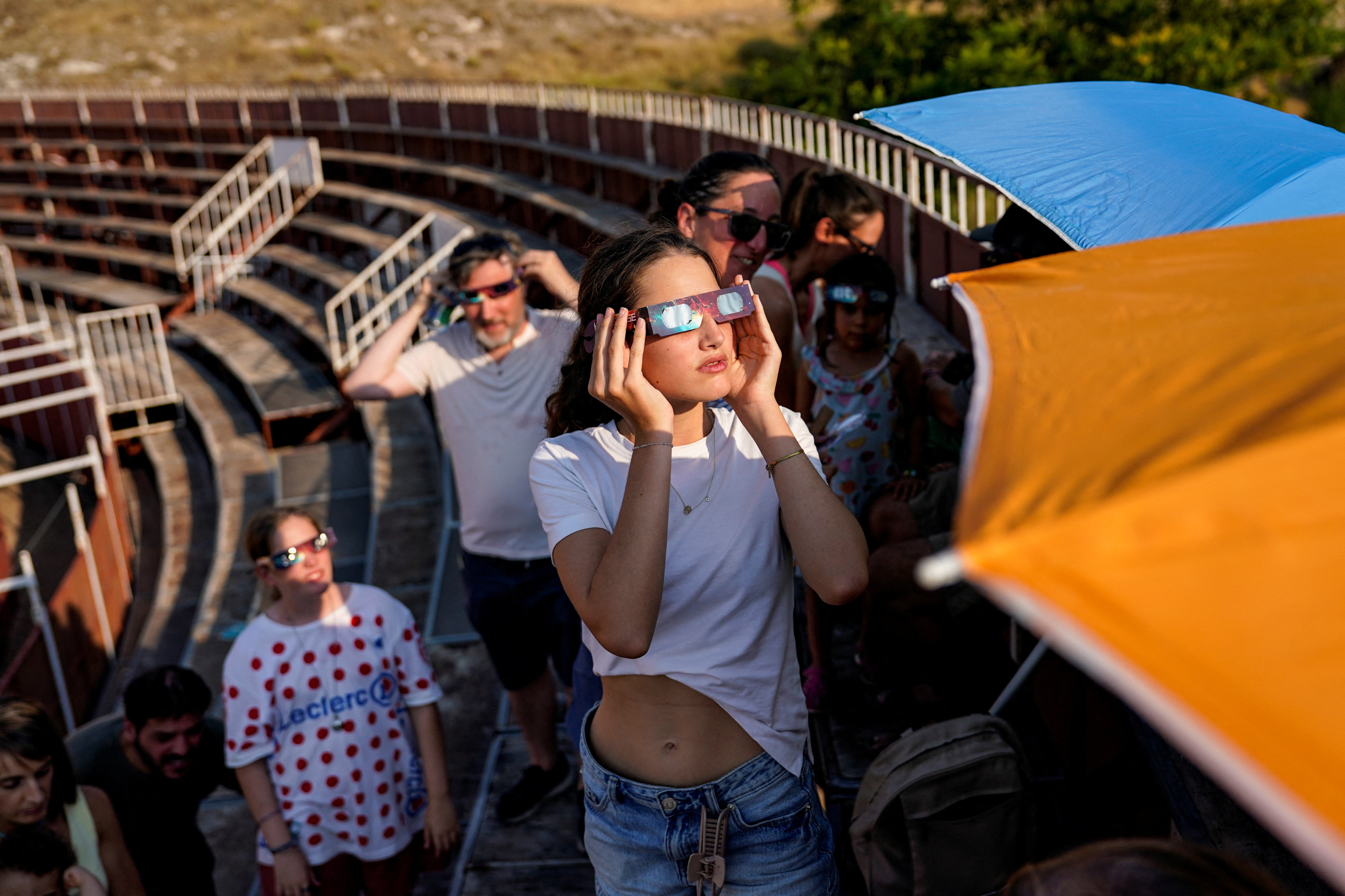 People test their protective glasses ahead of a solar eclipse, at a bullring in Villalba del Rey, Spain, August 12, 2026. (REUTERS)
